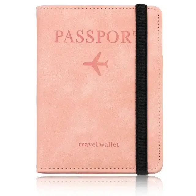 Pink leather passport holder with black elastic band featuring RFID blocking technology, stylish travel accessory.