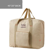 Load image into Gallery viewer, Large capacity foldable canvas travel bag in beige, designed for men and women, ideal for travel with convenient storage pocket.
