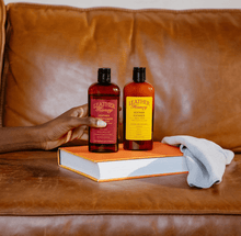 Load image into Gallery viewer, Leather Cleaner by Leather Honey on a leather sofa, ideal for cleaning car seats, jackets, furniture, vinyl, plastic, and more.
