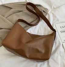 Load image into Gallery viewer, Retro luxury shoulder bag in brown PU leather, vegan tote, perfect for casual style, ample size for daily essentials, on beige fabric.

