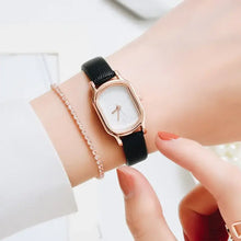 Load image into Gallery viewer, Oval Dial Retro Watch on wrist showcasing vintage-inspired elegance and sophistication with a classic black strap and rose gold accents.
