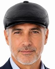 Load image into Gallery viewer, A man wearing a black leather flat cap, a light blue dress shirt, and a navy blue blazer, photographed against a solid white background.
