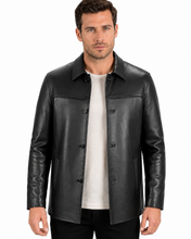 Charger l'image dans la galerie, A man wearing a black leather jacket over a white t-shirt and black pants, photographed against a solid white background.
