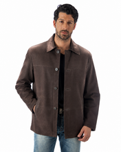 Charger l'image dans la galerie, A man wearing a dark brown suede jacket over a black shirt and blue jeans, standing against a plain white background.
