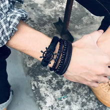 Load image into Gallery viewer, Stylish braided wrap leather bracelets with a nautical design worn on a wrist, showcasing quality craftsmanship and fashion.
