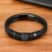 Load image into Gallery viewer, Woven leather rope stainless steel men&#39;s bracelet on a wooden surface, showcasing durable craftsmanship and sleek design.
