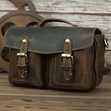 Load image into Gallery viewer, The Faust Leather Camera Bag | Crossbody Vintage Camera Messenger Bag in full-grain leather with buckles, rustic backdrop.
