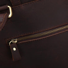 Load image into Gallery viewer, Close-up of zipper on The Gyda Backpack | Vintage Leather Travel Backpack, showing genuine dark leather texture.
