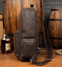 Load image into Gallery viewer, Side view of The Langley Backpack | Genuine Vintage Leather Backpack on wooden background
