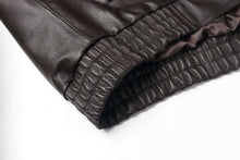 Load image into Gallery viewer, Close-up of the elastic cuff on a REED Men&#39;s genuine leather bomber jacket, showing detailed craftsmanship and luxurious material.
