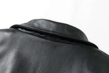 Load image into Gallery viewer, Close-up of black genuine leather on REED Men&#39;s American Style Bomber Jacket, showcasing texture and craftsmanship.
