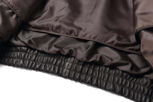 Load image into Gallery viewer, Close-up of REED Men&#39;s American Style Bomber Jacket with soft genuine leather and durable ribbed hem detail.
