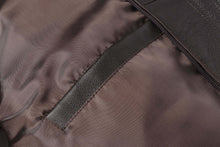 Load image into Gallery viewer, Close-up of REED Men&#39;s American Style Bomber Jacket inner lining and pocket, highlighting genuine leather craftsmanship.
