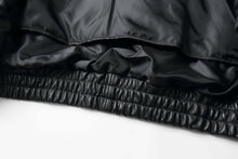 Load image into Gallery viewer, Close-up of REED Bomber Jacket&#39;s black genuine leather and inner lining detail
