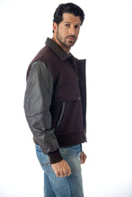 Load image into Gallery viewer, Model wearing REED men&#39;s leather varsity bomber jacket with wool body and leather sleeves, crafted in USA, stylish mid-weight design.
