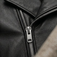 Load image into Gallery viewer, Close-up of a black leather jacket with a zipper, featuring the Combrard brand.

