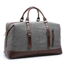 Load image into Gallery viewer, Retro large capacity canvas travel bag for men and women with brown leather straps, offering a stylish and functional luggage option.
