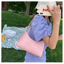 Load image into Gallery viewer, Woman holding crocodile pattern pink PU leather shoulder bag, perfect accessory for any occasion.
