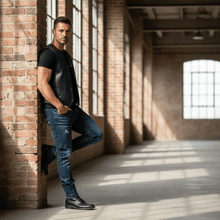 Load image into Gallery viewer, Man wearing REED Men&#39;s Soft Durable Motorcycle Leather Vest Black, 2 Inside Pockets - Imported, standing against a brick wall.
