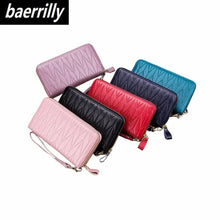 Load image into Gallery viewer, Assorted colors of leather female travel purses, designed for organization and style, featuring durable zippers and wrist straps.
