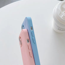 Cargar imagen en el visor de la galería, Pink and blue retro leather phone cases with vegan PU leather, showcasing slim design and rounded corners on a white surface.
