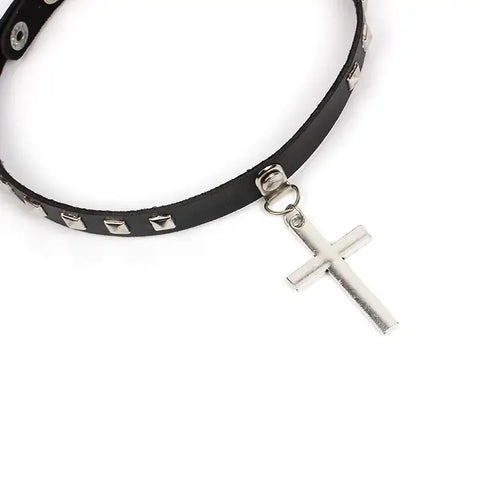 Leather cross choker necklace with punk-inspired design and silver studs. Unisex, fashion-forward accessory for bold style statements.