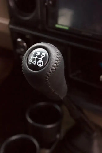 Leather gear knob kit for enhancing driving comfort and style in a car interior.