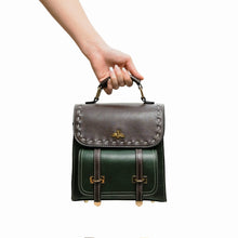 Charger l&#39;image dans la galerie, Hand holding Bumblebee vegan leather backpack in green and brown, featuring sleek design, perfect for professional style and organization.
