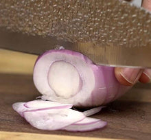 Load image into Gallery viewer, Close-up of eZthings 12&quot; Chef&#39;s Knife slicing a red onion, showcasing razor-sharp blade ideal for cutting vegetables in the kitchen.
