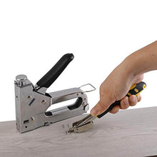 Load image into Gallery viewer, Heavy-duty eZthings staple gun in use, shown on wooden surface with nail remover, ideal for carpentry, upholstery, decoration, and furniture.
