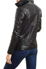 Load image into Gallery viewer, Woman wearing REED EST. 1950 black lambskin leather jacket with stand up collar, showcasing sleek design and premium quality.
