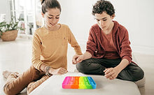 Load image into Gallery viewer, Children using eZthings heavy duty stress relief sensory toy, colorful push bubble fidget toy for kids and adults.
