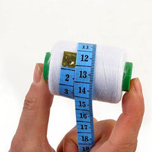 Load image into Gallery viewer, Hand holding white sewing thread spool with blue measuring tape wrapped around it
