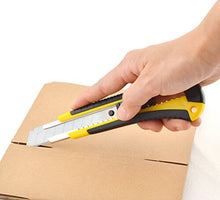 Cargar imagen en el visor de la galería, Person using eZthings 9mm snap-off box cutter on cardboard for precise cutting, ideal for wallpaper, vinyl, leather, and shrink-wrap.
