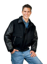 Load image into Gallery viewer, Man wearing black leather varsity bomber jacket with denim jeans, showcasing classic REED design, made in USA.
